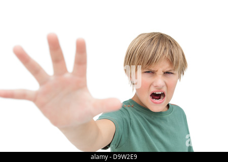 Furious little boy shouting and making stop sign with hand Stock Photo