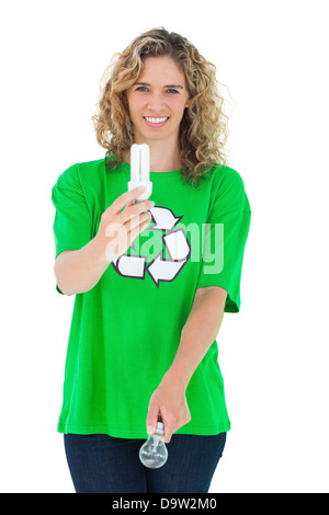Environmental activist holding energy saving light bulb and a light bulb Stock Photo
