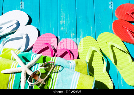 Colorful flip flops by a swimming pool. Stock Photo