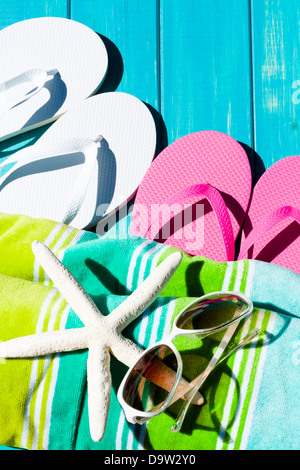 Colorful flip flops by a swimming pool. Stock Photo