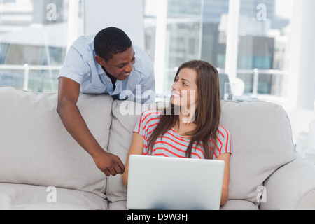 Cheerful creative designer talking to a colleague Stock Photo