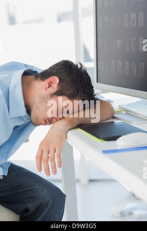 Graphic designer sleeping on his keyboard Stock Photo