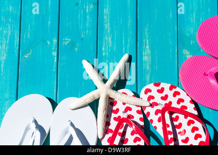 Colorful flip flops by a swimming pool. Stock Photo