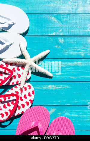 Colorful flip flops by a swimming pool. Stock Photo