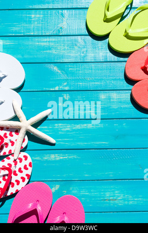 Colorful flip flops by a swimming pool. Stock Photo