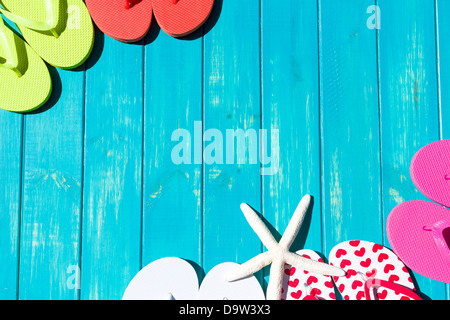 Colorful flip flops by a swimming pool. Stock Photo