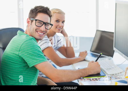 Attractive photo editors working together on graphics tablet Stock Photo