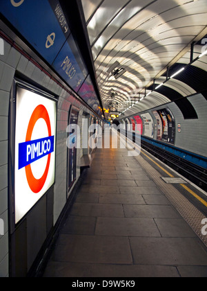 Interior of Pimlico station on the Victoria line showing platform and the famous London Underground logo Stock Photo