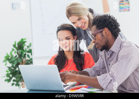 Three designers working together on a laptop Stock Photo