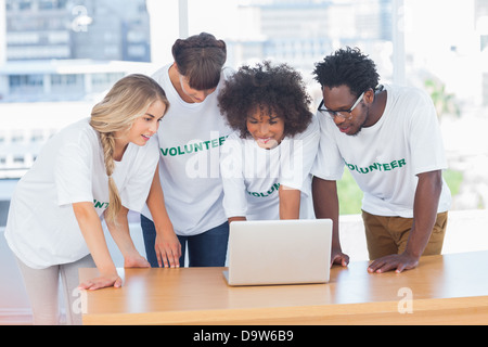 Volunteers working together on a laptop Stock Photo