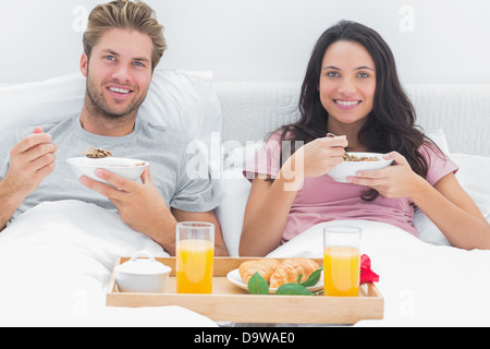 Couple eating cereal during a romantic breakfast Stock Photo