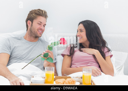 Man offering a rose to his wife Stock Photo