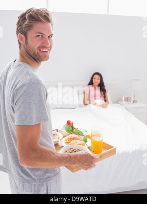 Man bringing breakfast to his wife Stock Photo