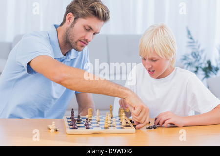 Father and his son playing chess Stock Photo