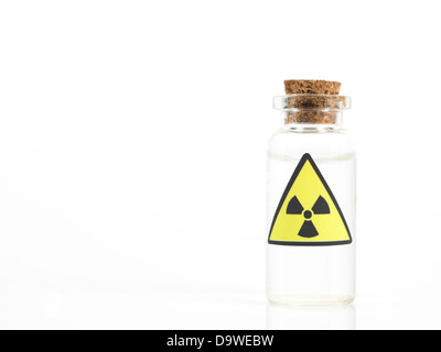 white background with a small glass transparent bottle with a brown cork and a radioactivity warning label Stock Photo