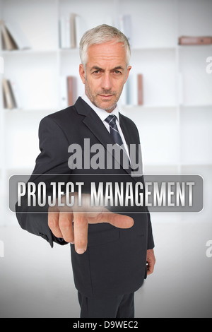 Serious businessman touching the term project management Stock Photo