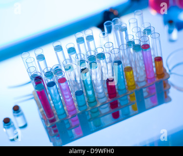 close-up of rack of medical tubes filled with colorful fluids placed on table in a laboratory Stock Photo