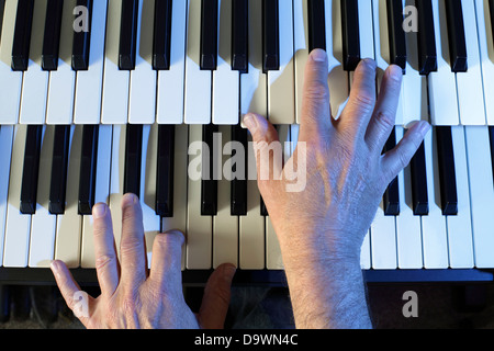 Playing a two manual electric keyboard. Stock Photo