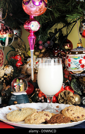 Milk and cookies under Christmas tree. Stock Photo