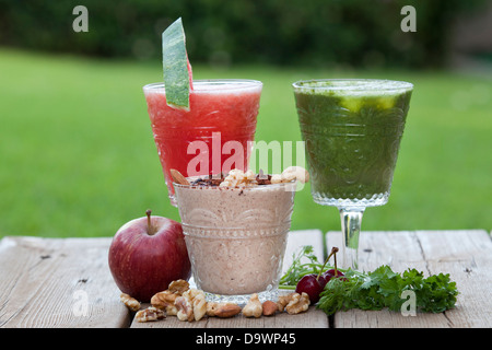 Fruit Smoothies - watermelon (left) grapes (right) nuts (centre) Stock Photo