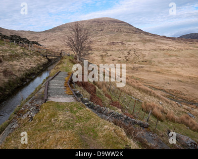 Leat running across the flanks of Pen Llithrig y Wrach, feeding Llyn Cowlyd reservoir in Snowdonia's Carneddau mountains. Stock Photo