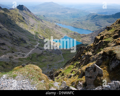 View down Cwm Dyli across Glaslyn and Llyn Llydaw from Snowdon's summit slopes. Crib Goch left and Moel Siabod in the distance Stock Photo