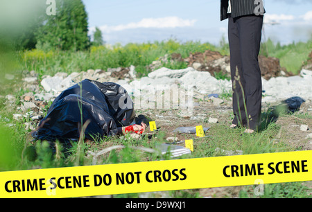 Young female criminalist inspecting crime scene Stock Photo