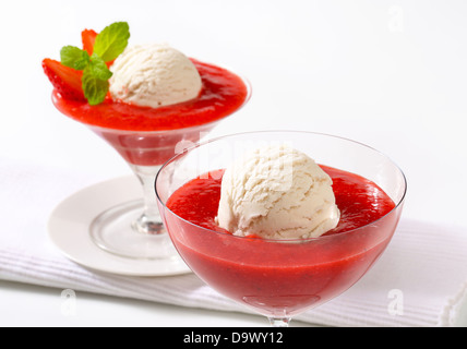 Ice cream with strawberry puree in stemmed glasses Stock Photo