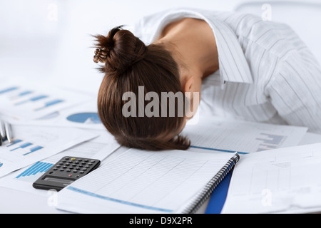 woman sleeping at work in funny pose Stock Photo