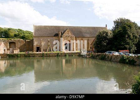 Thatched Tithe Barn and pond Abbotsbury Dorset England UK Stock Photo