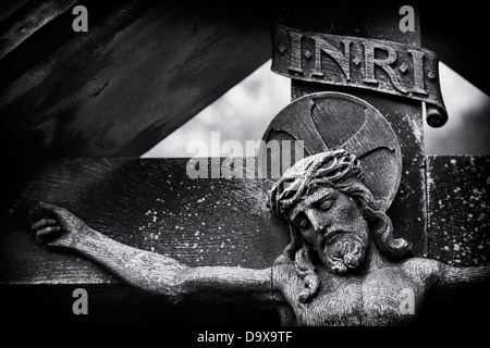 Wooden Statue of Jesus christ on the cross. Wyck Rissington, Cotswolds, Gloucestershire, England. Monochrome Stock Photo