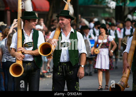 Bavarian guest musicians carrying their Alphorn instruments during the Oktoberfest parade Stock Photo