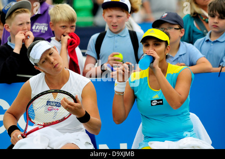 Sania Mirza (India) and Liezel Huber (USA) playing doubles. Children watching at Eastbourne, 2013 Stock Photo