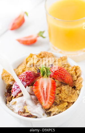 Healthy breakfast with whole grain cereal with milk, fresh strawberry and orange juice Stock Photo
