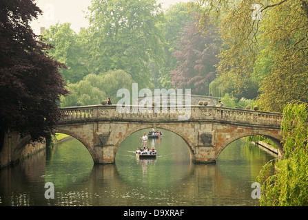 A punt passes under Clare College Bridge on the River Cam in Cambridge. Stock Photo