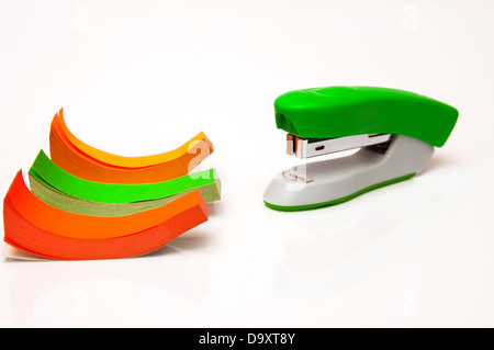 stapler with colored paper on a white background Stock Photo