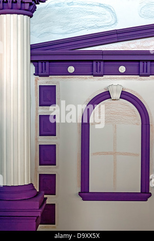 Artificial cheerful facade of a house in purple and white colors. Stock Photo
