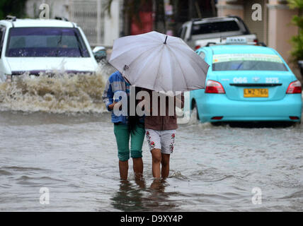 Davao, Philipinnes. 28th June 2013. Filipino residents maneuvers as they try to pass in a flooded road cause by a heavy downpour of rain in Davao city, Southern Philippines, 28 June 2013. According to Philippine Atmospheric Geophysical and Astronomical Services Administration (PAGASA), Storm Signal Number One is raised in areas of Visayas and Mindanao as tropical depression 'Gorio' enters Philippine territory. Credit:  Eli Ritchie Tongo/Alamy Live News Stock Photo