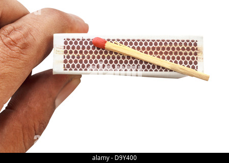 Match on matchbox with hand holding isolate Stock Photo