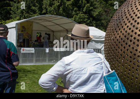 Dublin, Ireland, 26 May 2013: Visitors stand beside a perforated metal sphere near a festival stage at Africa Day 2013 at Farmleigh House. Stock Photo