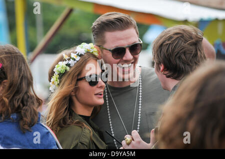 Glastonbury, UK. 28th June 2013. GLASTONBURY MUSIC FESTIVAL Musician rapper Professor Green who is performing this year at Glastonbury. Pictured with his fiance Millie Mackintosh  Friday Day 2 of the 2013 Glastonbury Festival at Worthy Farm. June 28. 2013. GLASTONBURY MUSIC FESTIVAL PILTON, SOMERSET, ENGLAND, UK Credit:  Alistair Heap/Alamy Live News Stock Photo