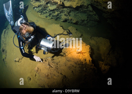 Mexico, Cozumel, Cenote Aerolito de Paraiso, Woman diving, high angle view Stock Photo