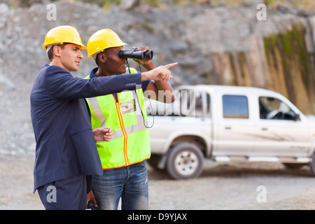 handsome mine manager showing foreman mining site Stock Photo