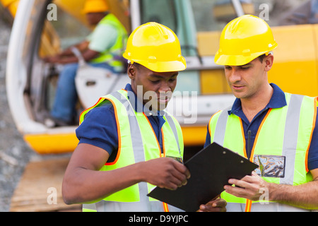 construction co-workers discussing about work plan construction site Stock Photo