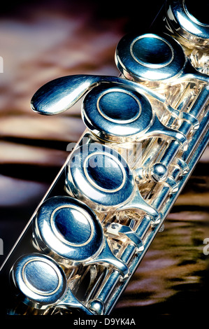 Close view of a segment of a silver flute. Stock Photo