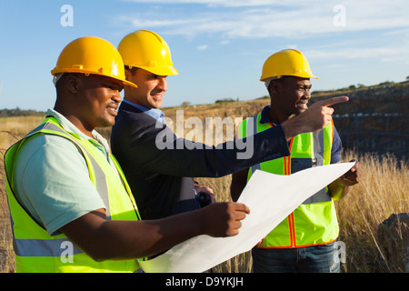 mine manager and workers at quarry discussing future plan Stock Photo