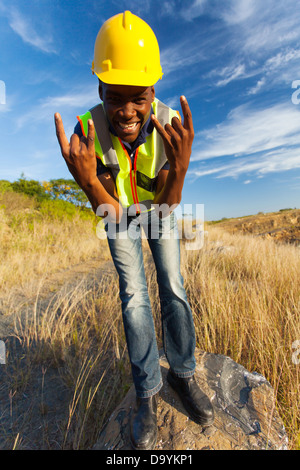 happy African construction worker outdoors Stock Photo