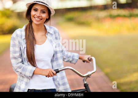 happy young woman riding her bike outdoors at the park Stock Photo