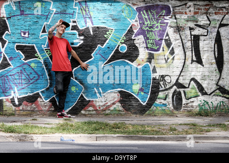 A greeting young Rapper greeting in front of a Graffiti wall Stock ...