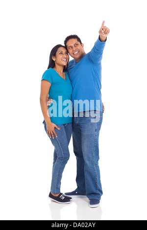 cheerful young married indian couple pointing on white background Stock Photo